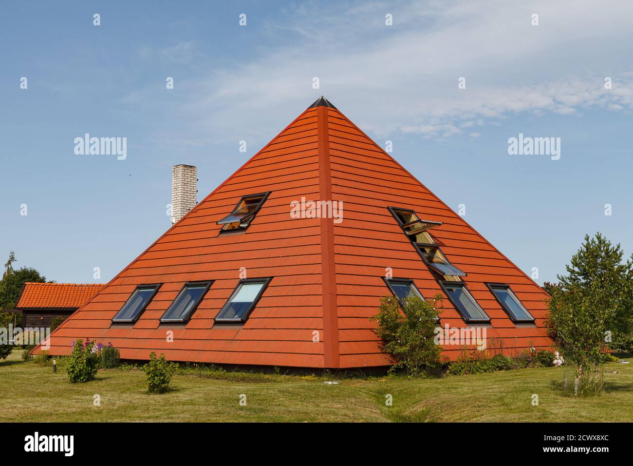 House build as pyramid. Tiled roof. Oriental approach used in Europe