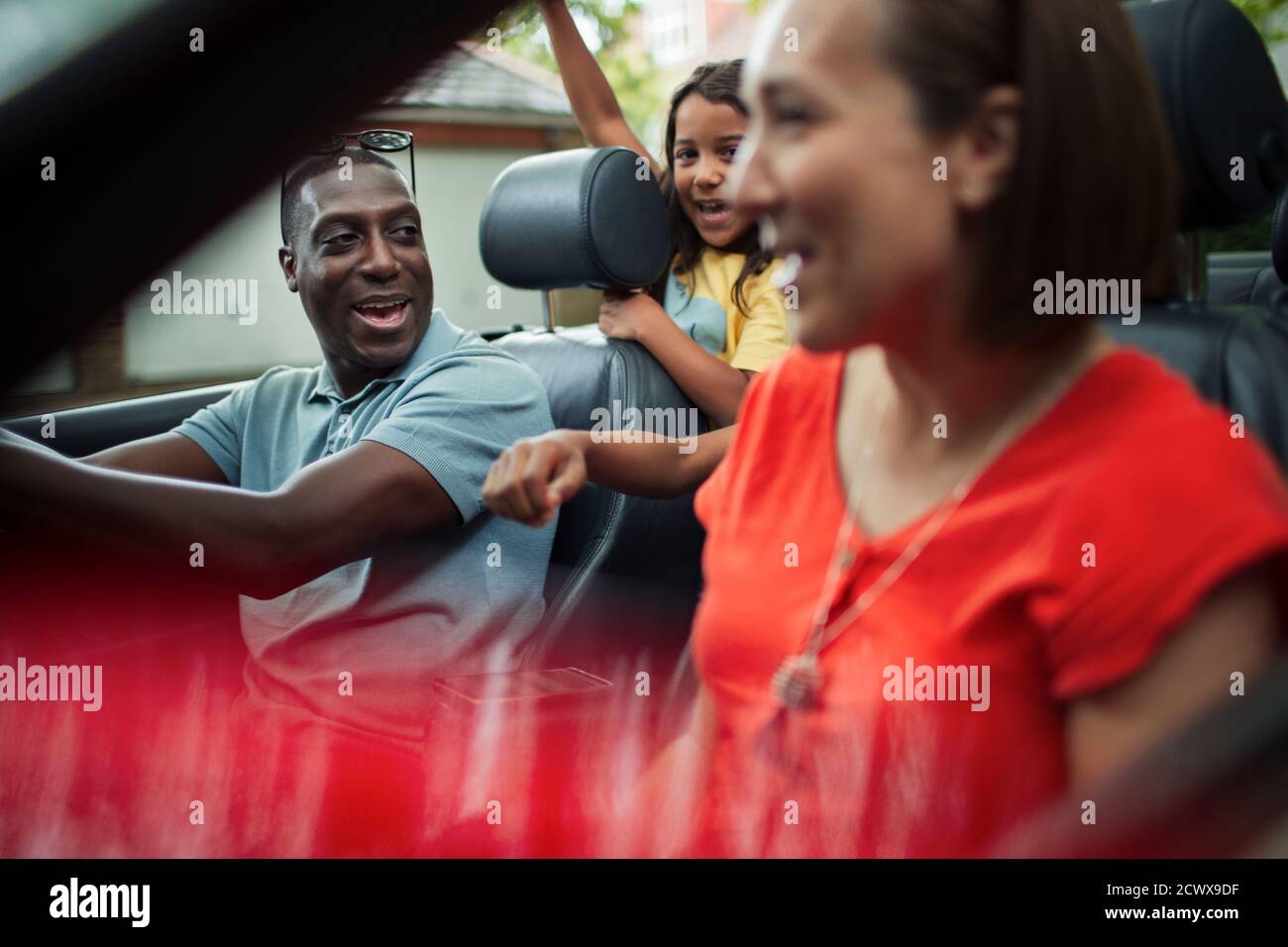 Happy family riding in convertible Stock Photo