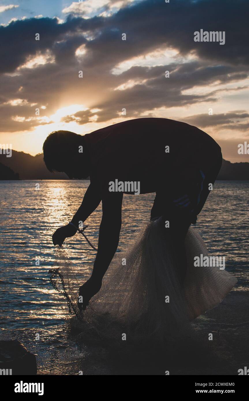 Fisherman and the sunset Stock Photo - Alamy