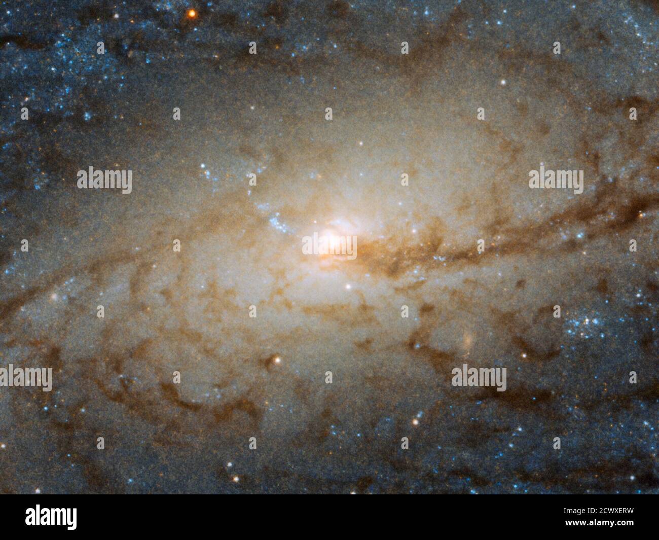 Hubble Spies Galactic Traffic Jam The barred spiral galaxy NGC 3887, seen here as viewed by the Wide Field Camera 3 aboard the NASA/ESA Hubble Space Telescope, lies over 60 million light-years away from us in the southern constellation of Crater (the Cup). It was discovered on Dec. 31, 1785, by astronomer William Herschel.  Its orientation to us, while not exactly face-on, allows us to see NGC 3887’s spiral arms and central bulge in detail, making it an ideal target for studying a spiral galaxy’s winding arms and the stars within them.   The very existence of spiral arms was for a long time a Stock Photo