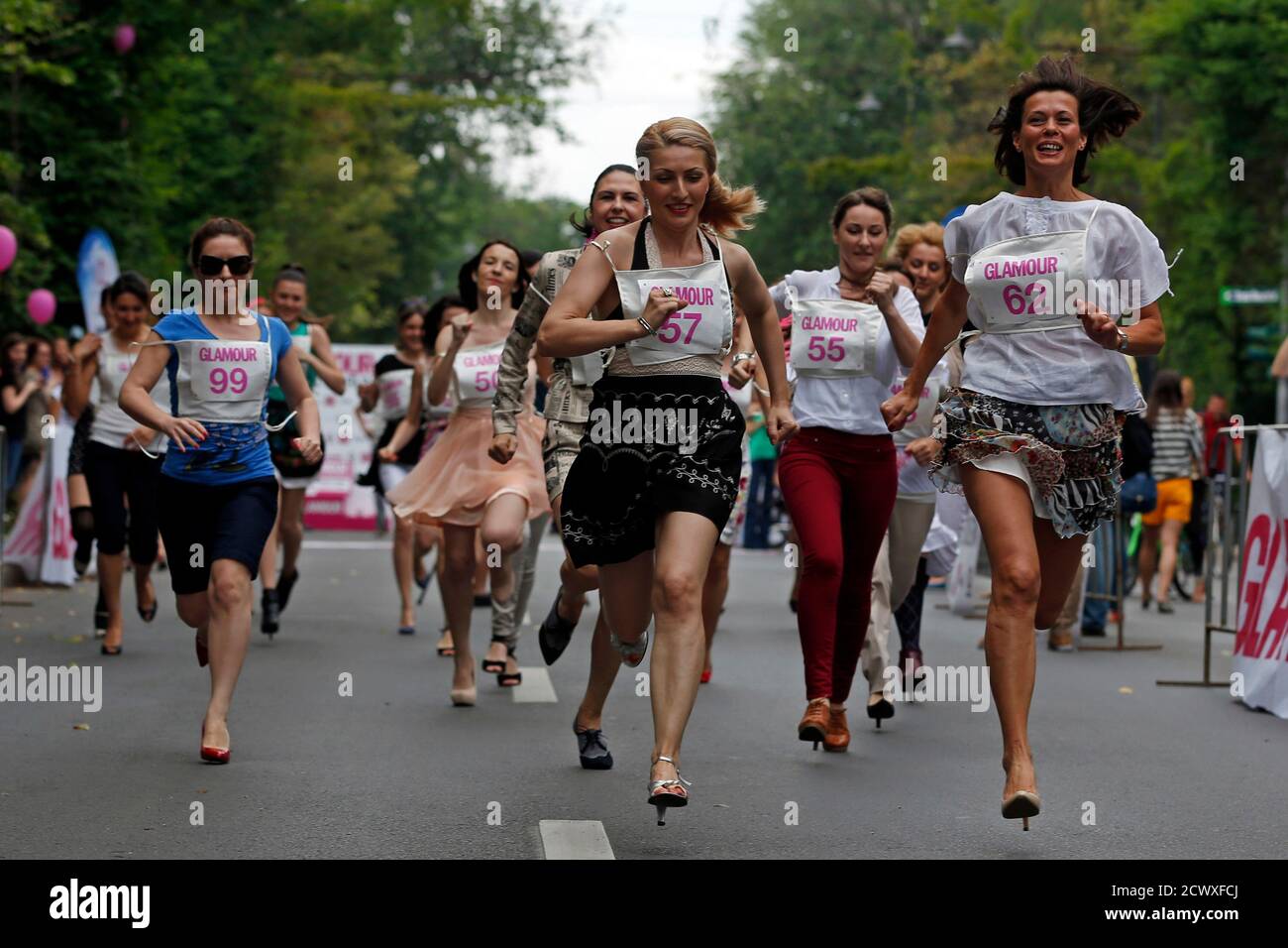 Participants run in high-heels during the warm-up of the Stiletto Run in  Bucharest June 14, 2014. The annual 50 metres race requires participants to  wear high-heels that are at least 7cm tall.