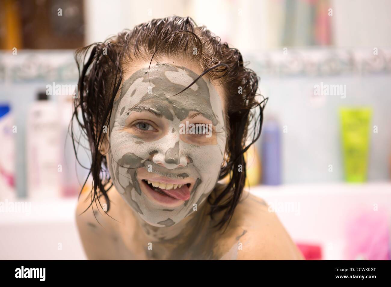 Beautiful girl with mud on his face. Cosmetic mask. Beauty face. Stock Photo