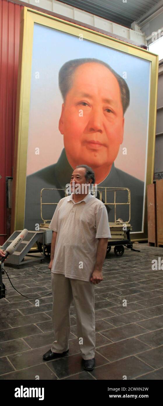 Ge Xiaoguang stands in front of a giant portrait of China's late Chairman Mao Zedong during a interview with Reuters in his working studio located between the Tiananmen Square and the Forbidden City in Beijing, June 29, 2011. Reclusive Chinese painter Ge's art has gazed over one of the world's most famous city squares for decades. For 30 years, he has painted the portraits of former paramount leader Mao Zedong that look across Beijing's Tiananmen Square. The giant oil paintings of the "Great Helmsman" have kept watch from the Gate of Heavenly Peace since the Communist Party won the civil war a Stock Photo
