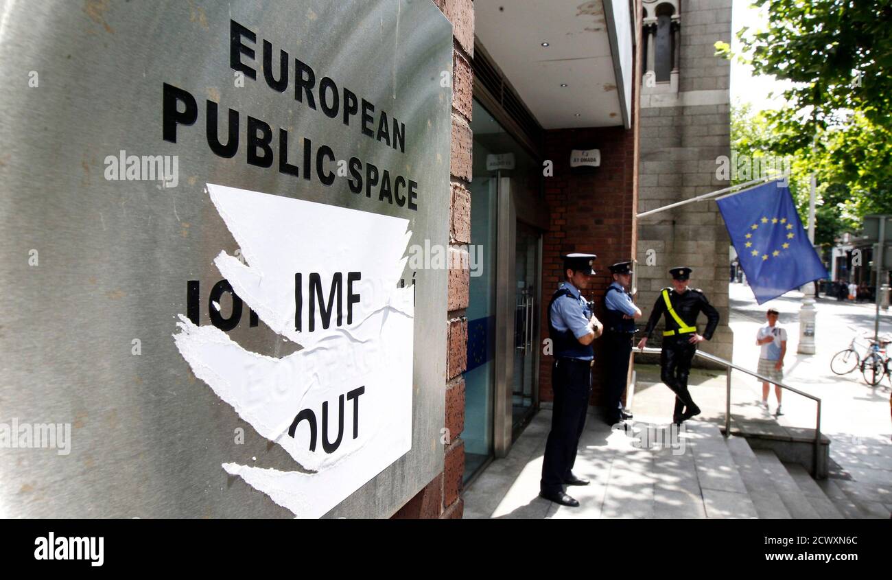Members of the Gardai patrol outside the Dawson Street offices where the European Commission, European Central Bank and International Monetary Fund (IMF) held a joint news conference outlining Ireland's progress in meeting its targets as part of the EU/IMF bailout, in Dublin July 14, 2011. Rating agencies may be overestimating the risks associated with the current euro zone debt crisis and were it not for the contagion risk, Irish bond spreads would be narrower, a senior IMF official said on Thursday. REUTERS/Cathal McNaughton (IRELAND - Tags: BUSINESS POLITICS) Stock Photo