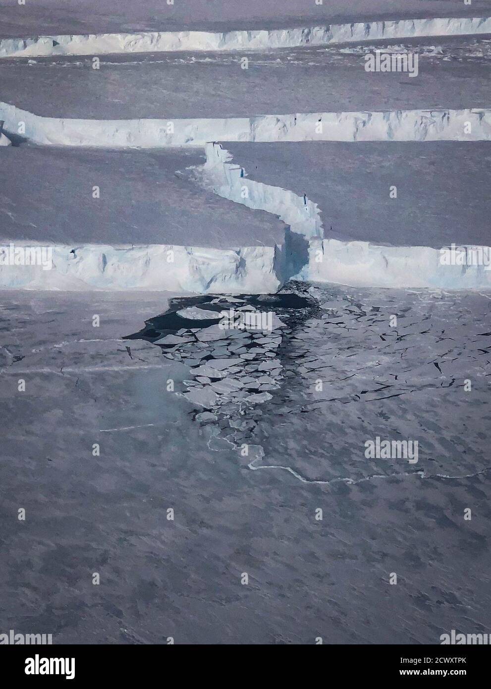 Massive Antarctic Iceberg Spotted on NASA IceBridge Flight Caption: New sea ice forms in a rift created when the B-46 iceberg broke off from Pine Island Glacier. Stock Photo