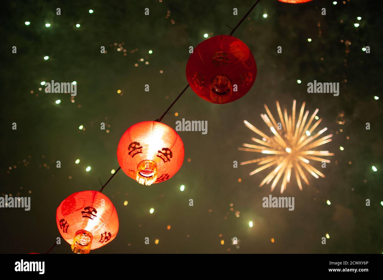 Chinese lanterns with the background of colorful fireworks shot to