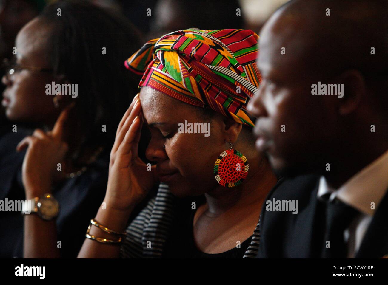 South African expatriates listen to a eulogy during a memorial service for former South African President Nelson Mandela at St George Church in Singapore December 12, 2013. The anti-apartheid hero's death on December 5 at the age of 95 has brought an outpouring of grief and mourning, as well as celebration and thanksgiving for his life and achievements. REUTERS/Edgar Su (SINGAPORE - Tags: POLITICS OBITUARY) Stock Photo