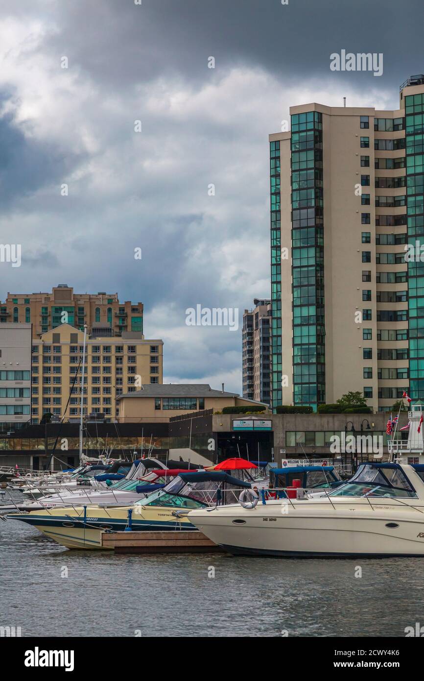 Kingston, Ontario, August 2014 - Boats in the marina of Kingston waterfront, with buildings in the background. Vertical shot Stock Photo