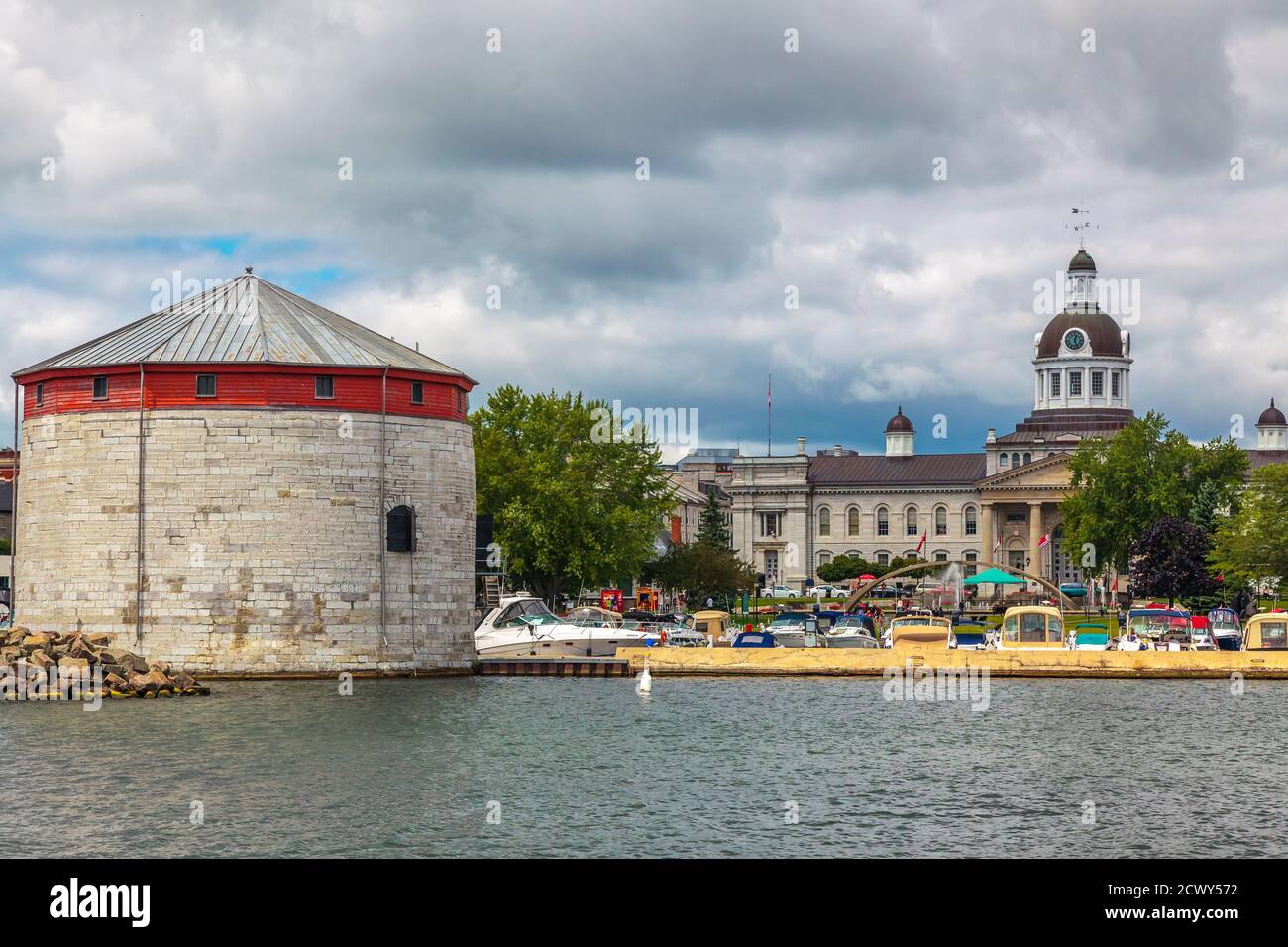 Shoal tower, Kingston, Ontario, August 2014 - Boats and limestone fortification on the waterfront with city hall in the background Stock Photo