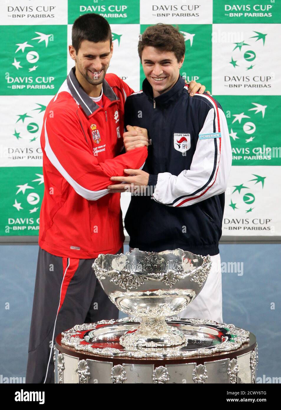 Serbia's Novak Djokovic (L) and France's Gilles Simon pose with the Davis Cup trophy after the official draw at Belgrade Arena in Belgrade December 2, 2010. Serbia and France will play their Davis Cup final tennis match from December 3-5 in Belgrade. REUTERS/Marko Djurica (SERBIA - Tags: SPORT TENNIS) Stock Photo