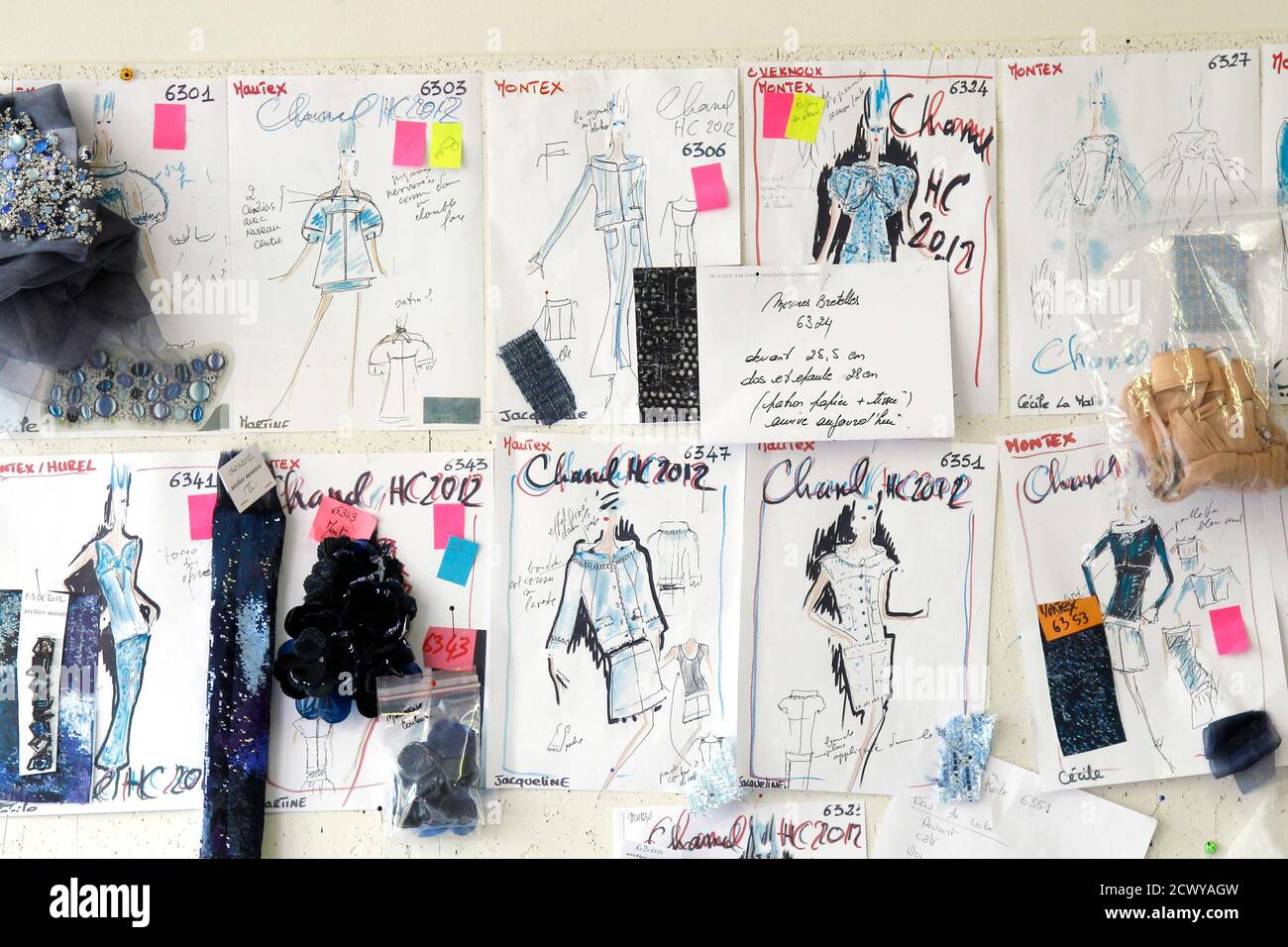 Drawings of Haute Couture Chanel dresses by designer Karl Lagerfeld and Montex embroidery specimen are displayed in the office of the Montex Artistic director at the luxury Montex embroidery workshop in Paris January 18, 2012. Embroidery House Montex, specialized in the creation of embroidery of hook Luneville, the needle and the cornely, was created in 1939 and acquired by Chanel last December. Picture taken January 18, 2012.  REUTERS/Benoit Tessier (FRANCE - Tags: FASHION) Stock Photo