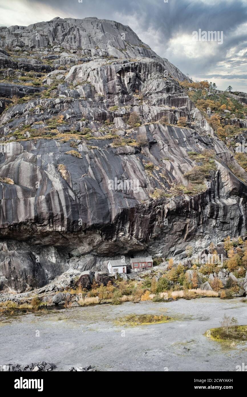 Jøssingfjord Helleren rock formation with sheltered houses. Long shot. Stock Photo