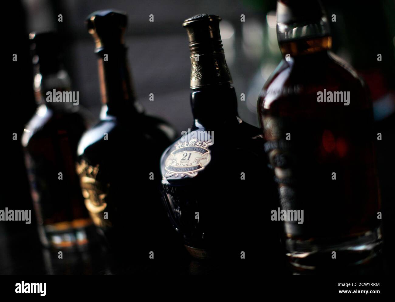 Bottles of Chivas Regal are seen on a table during a Reuters interview with Darren Hosie, Regional Manager of Chivas Brothers in Shanghai, December 8, 2010. Born and bred in Glasgow, 37-year-old Darren Hosie has spent the past seven years working for scotch whisky giant Pernod Ricard and since August 2007, he has lived in China as international brand ambassador for the firm's top whisky brands Chivas Regal, Ballantine's and The Glenlivet. Hosie is well accustomed to the tastes and whims of the country's new business elite -- the legions of bankers, entrepreneurs, traders and second-generation  Stock Photo