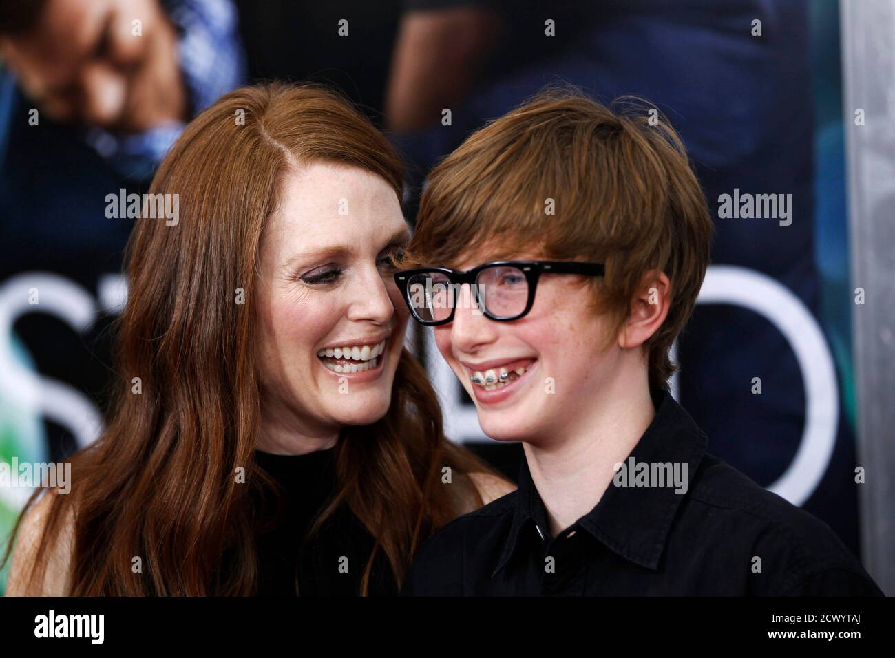 Cast member Julianne Moore arrives with her son, Caleb Freundlich, for the premiere of her film 'Crazy, Stupid, Love' in New York July 19, 2011.   REUTERS/Lucas Jackson (UNITED STATES - Tags: ENTERTAINMENT) Stock Photo