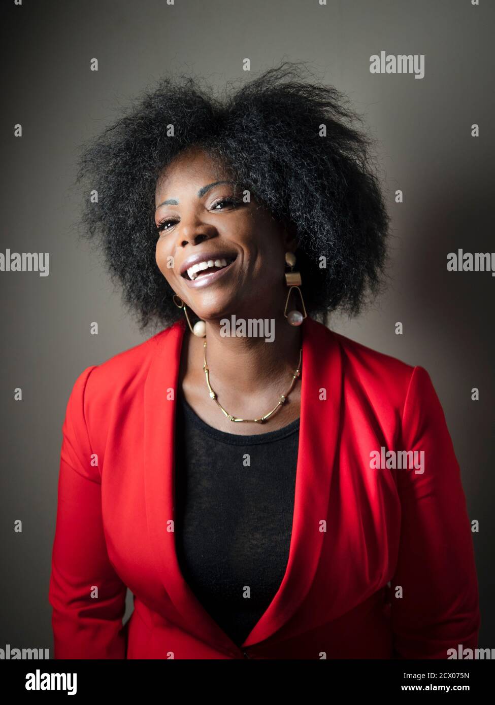 vertical portrait of an attractive African American woman laughing Stock Photo