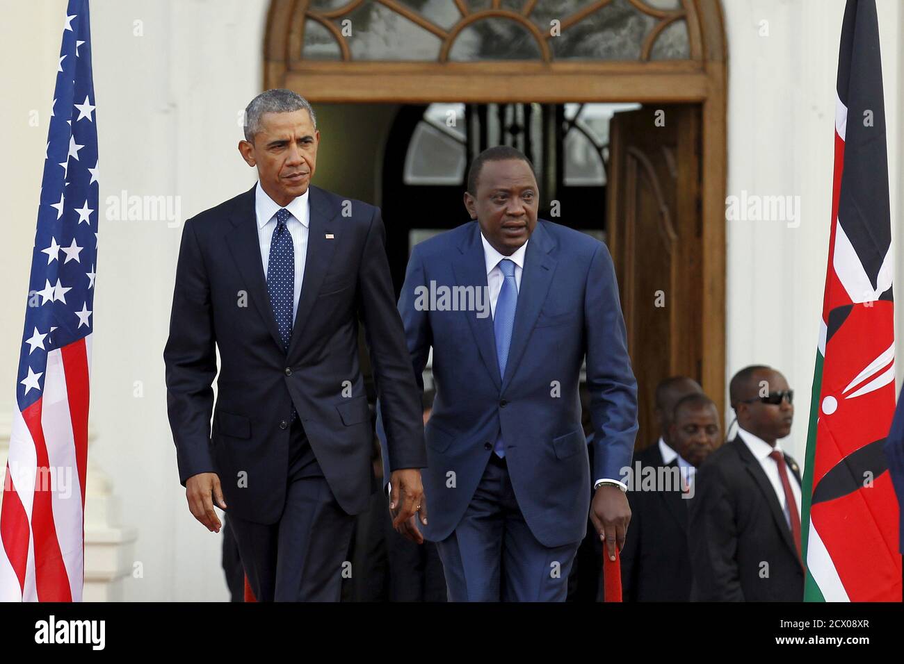 U.S. President Barack Obama (L) arrives together with Kenya's President Uhuru Kenyatta (R) to hold a joint news conference after their meeting at the State House in Nairobi July 25, 2015. Obama told African entrepreneurs in Kenya on Saturday they could help counter violent ideologies and drive growth in Africa, and said governments had to assist by ensuring the rule of law was upheld and by tackling corruption. REUTERS/Thomas Mukoya Stock Photo