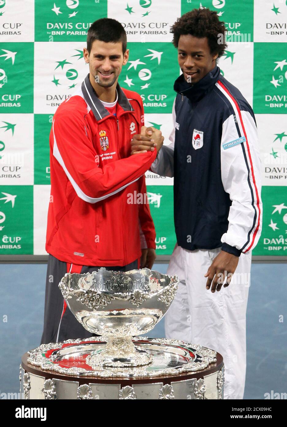 Serbia's Novak Djokovic (L) and France's Gael Monfils pose with the Davis Cup trophy after the official draw at Belgrade Arena in Belgrade December 2, 2010. Serbia and France will play their Davis Cup final tennis match from December 3-5 in Belgrade. REUTERS/Marko Djurica (SERBIA - Tags: SPORT TENNIS) Stock Photo