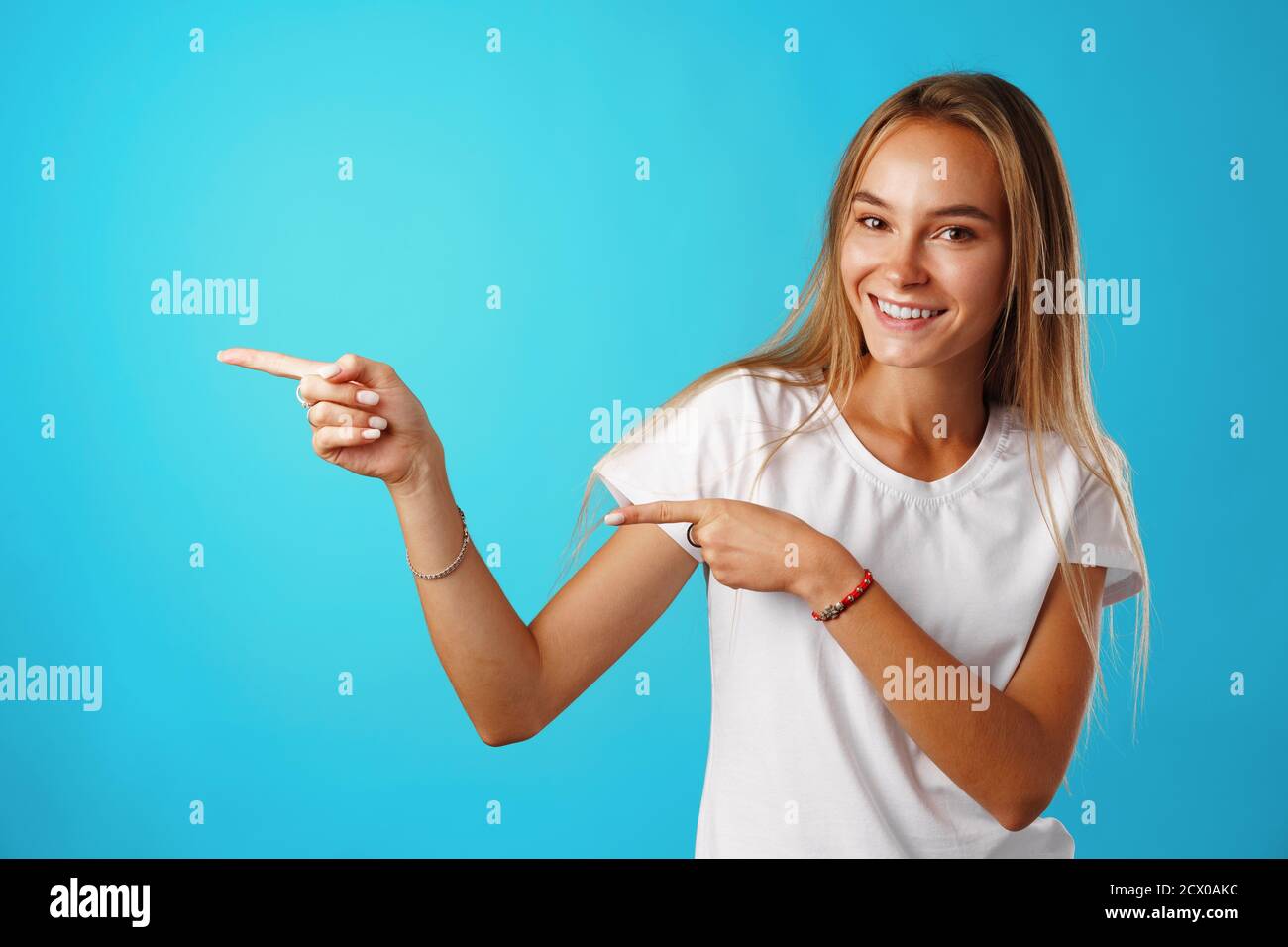 Portrait charming pretty cheerful girl showing copy space Stock Photo ...