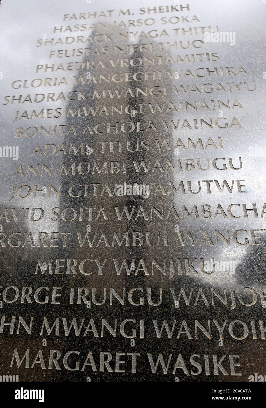 Names of the 248 people killed in the 1998 bombing of the U.S.embassy are seen on the memorial wall in Nairobi May 2, 2011. Al Qaeda leader Osama bin Laden was killed in a U.S. helicopter raid on a mansion near the Pakistani capital Islamabad early on Monday, officials said, ending a nearly 10-year worldwide hunt for the mastermind of the Sept. 11 attacks. The Cooperative Bank building, which was also damaged in the August 7, 1998 truck bomb attacks aimed at U.S. embassies in Kenya, is reflected on the memorial wall.  REUTERS/Thomas Mukoya (KENYA - Tags: CONFLICT CIVIL UNREST POLITICS) Stock Photo