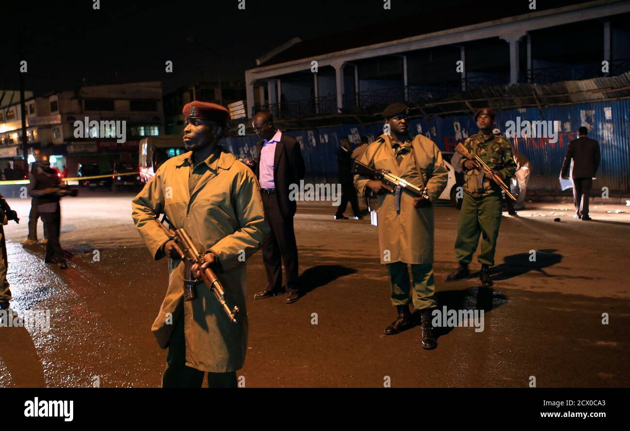 Policemen secure the scene of an explosion in Kenya's capital Nairobi October 24, 2011. The grenade explosion in the centre of Nairobi on Monday evening killed one person and wounded at least eight, the police said. REUTERS/Thomas Mukoya (KENYA - Tags: CIVIL UNREST CRIME LAW) Stock Photo
