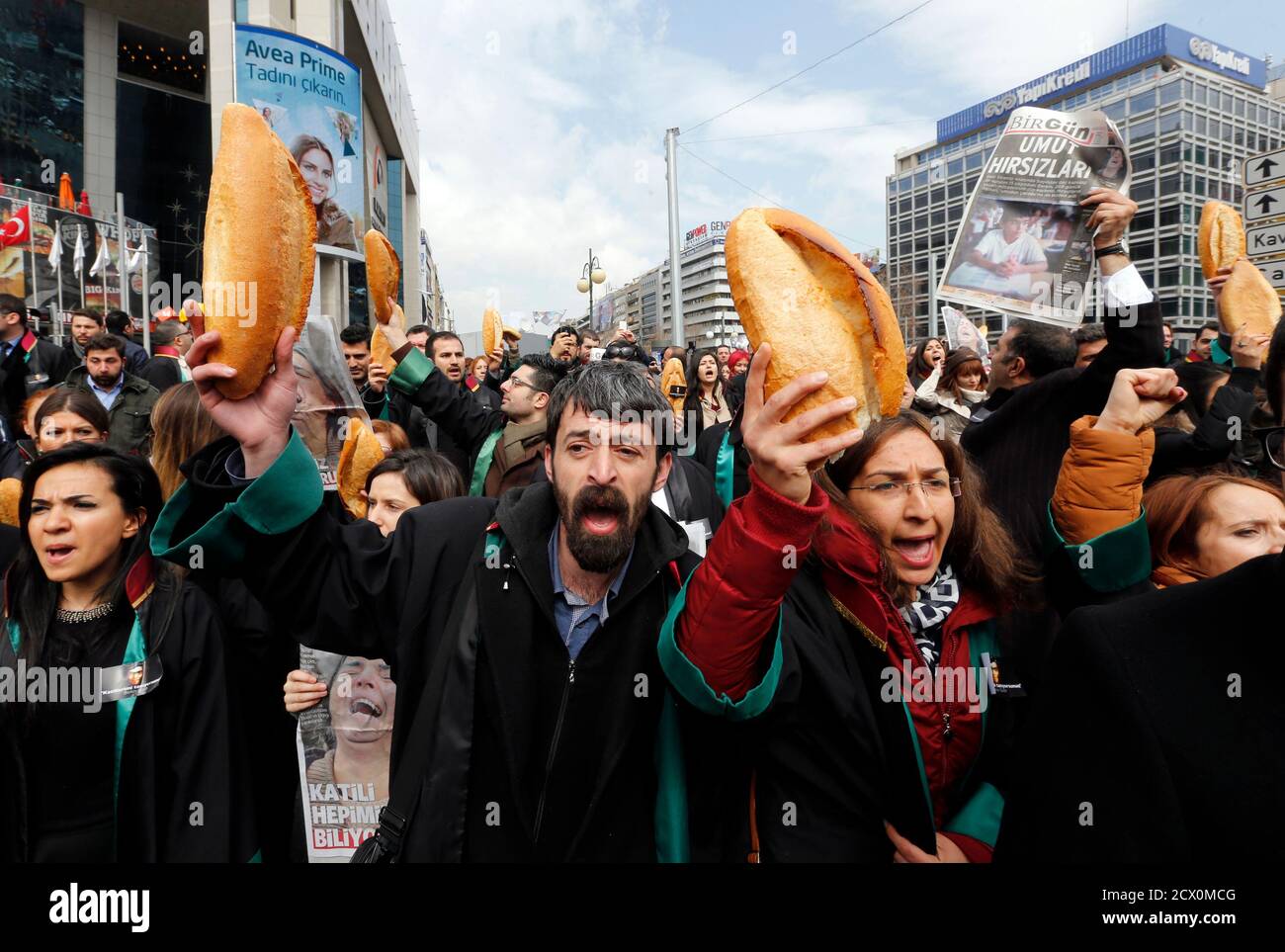 Anti-government protesters carry bread during a demonstration marking the funeral of Berkin Elvan in Ankara March 12, 2014. Several thousand mourners gathered in central Istanbul and Ankara on Wednesday for the funeral of Elvan, a 15-year-old boy wounded during anti-government demonstrations last summer whose death on Tuesday triggered protests across Turkey. Elvan, then aged 14, got caught up in street battles in Istanbul between police and protesters on June 16, 2013 while going to buy bread for his family. REUTERS/Umit Bektas (TURKEY  - Tags: POLITICS CIVIL UNREST) Stock Photo