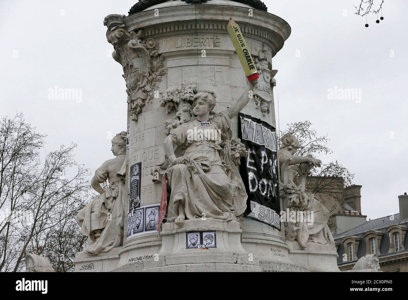 The statue at the Place de la Republique in Paris is seen featured with a giant cardboard pencil reading 'I'm Charlie' January 12, 2015.  At least 3.7 million people took part in silent marches throughout the country, the biggest public demonstration ever registered in France. A total of 1.2 million to 1.6 million marched in Paris and a further 2.5 million in other cities, the Interior Ministry said.  REUTERS/Gonzalo Fuentes (FRANCE) Stock Photo