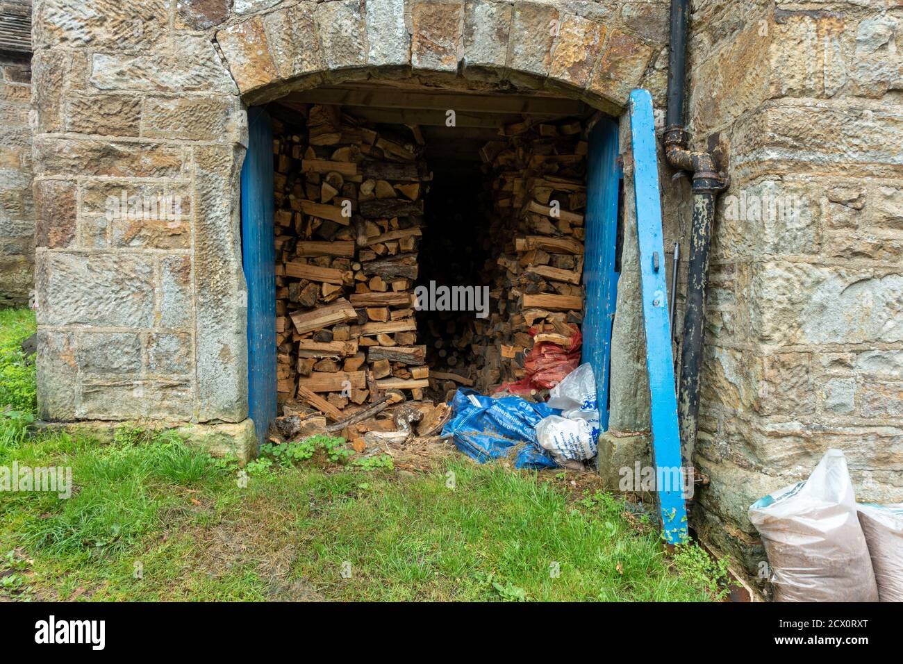firewood fuel store inside a barn conversion - cut logs for home use for a wood burning stove, Yorkshire, UK Stock Photo