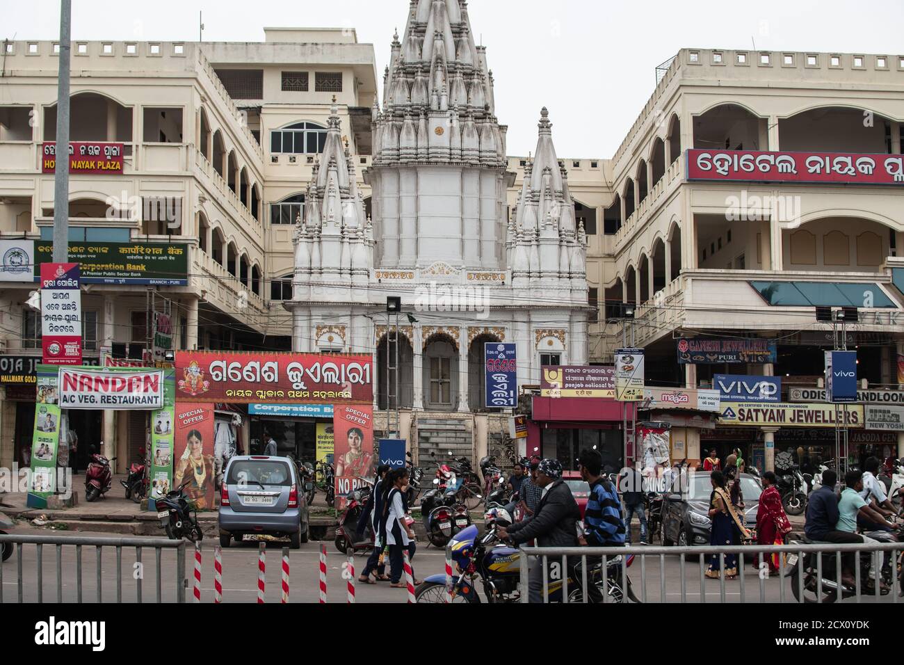 Puri, India - February 3, 2020: Street view of traffic in front of a small white hindu temple close to Jagannath on February 3, 2020 in Puri, India Stock Photo