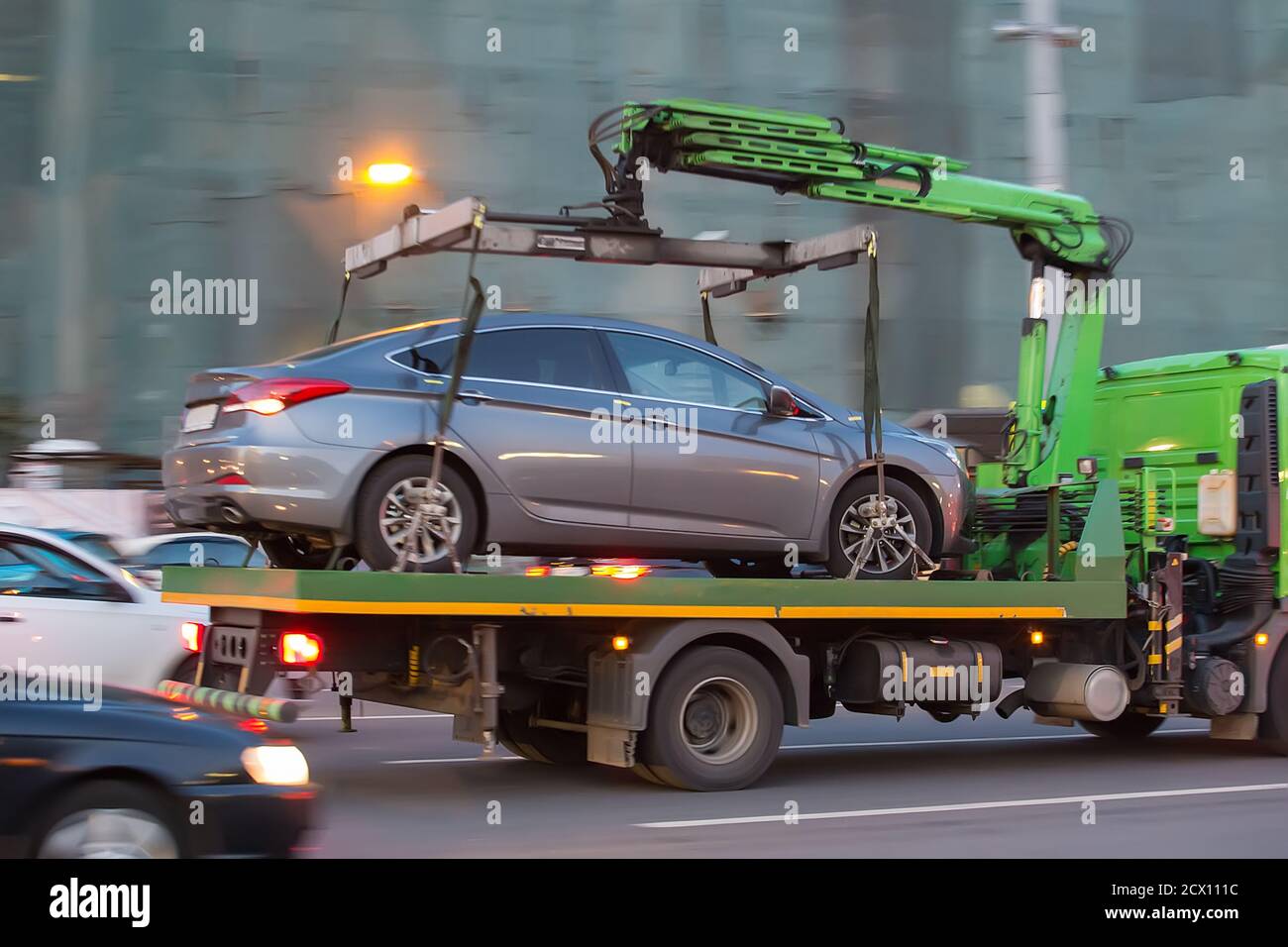 tow truck transports cars on city street Stock Photo Alamy