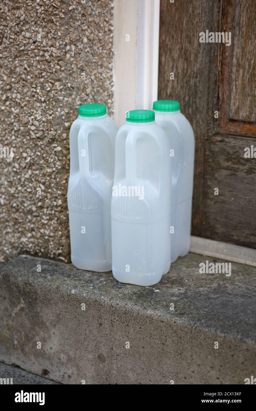 Empty plastic milk bottles on doorstep hires stock photography and