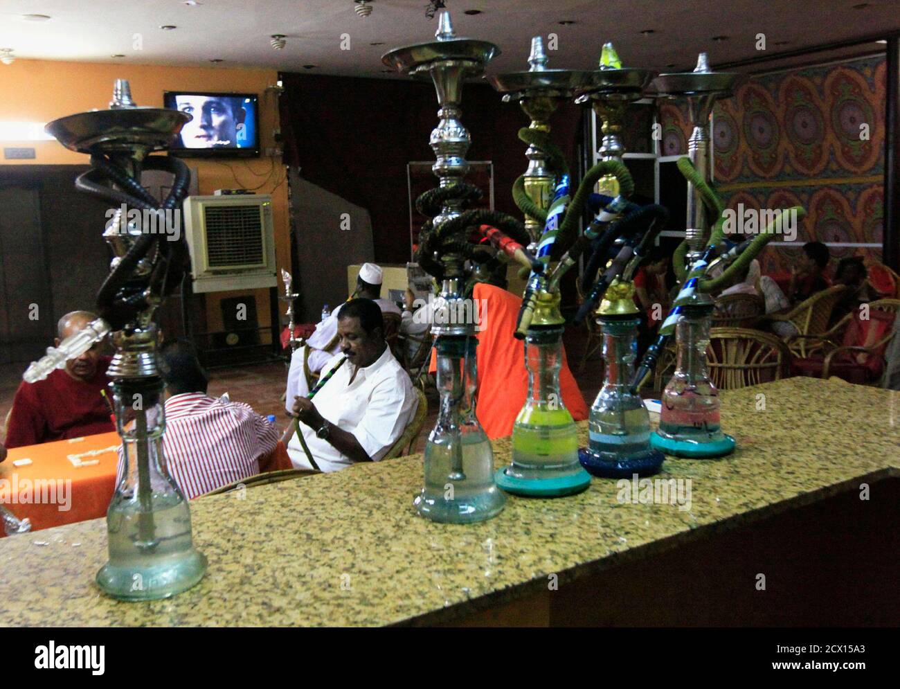 Customers Watch Tv And Play Domino As They Smoke Waterpipes At A Shisha Cafe In Khartoum April 28 2013 Local Authorities Have Allowed Shisha Smoking Back In Touristic Hotels And Restaurants And