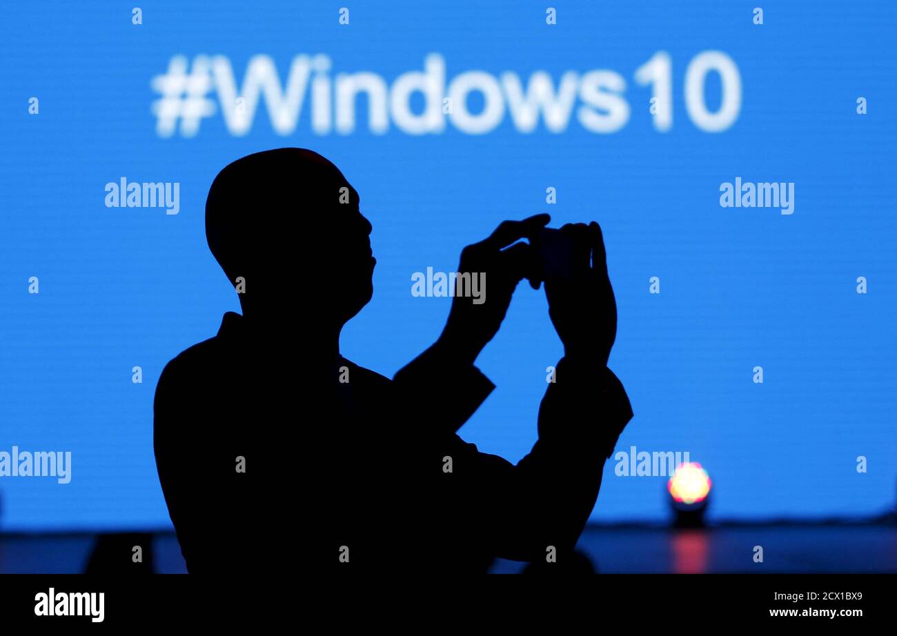 A Microsoft delegate takes a picture during the launch of the Windows 10 operating system in Kenya's capital Nairobi, July 29, 2015. Microsoft Corp's launch of its first new operating system in almost three years, designed to work across laptops, desktop and smartphones, won mostly positive reviews for its user-friendly and feature-packed interface. REUTERS/Thomas Mukoya Stock Photo