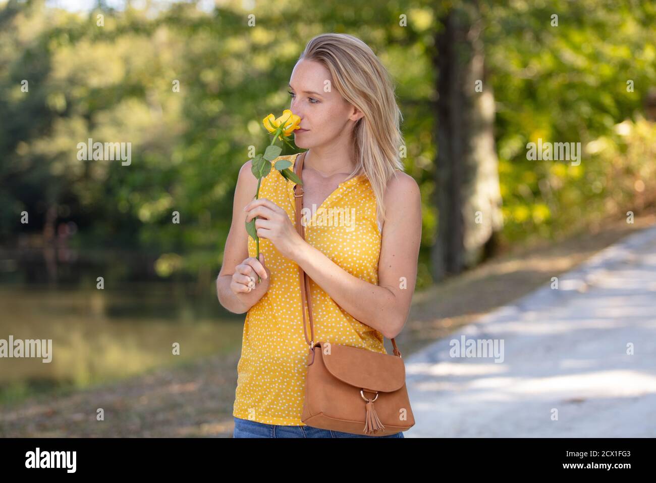 young woman in her garden holding flowers Stock Photo - Alamy