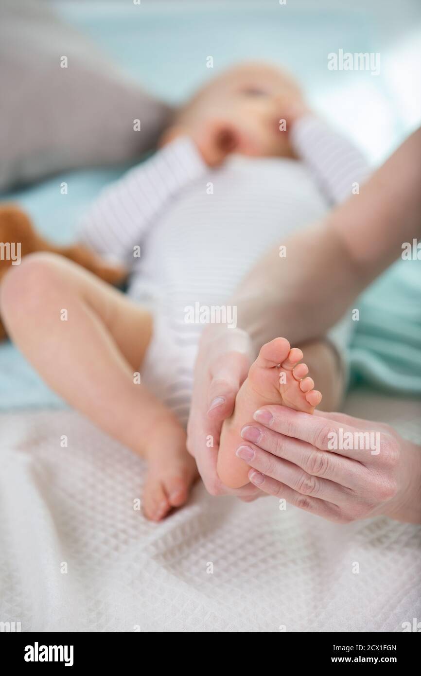 closeup baby foot massage on the bed Stock Photo Alamy