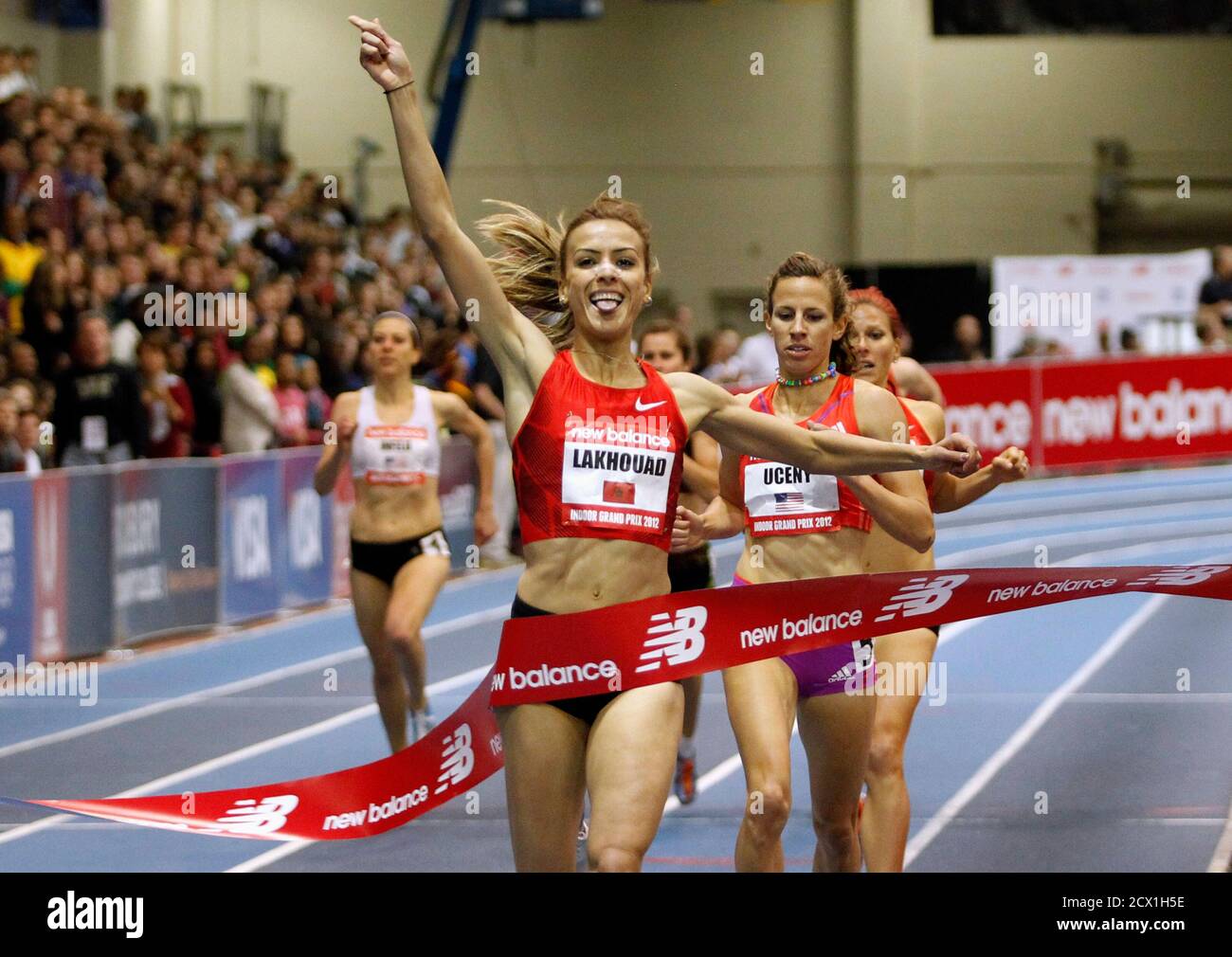 Morocco's Btissam Lakhouad (C) gestures as she crosses the finish line to  win the women's 1000 meter run at the New Balance Indoor Grand Prix track  meet in Boston, Massachusetts February 4,