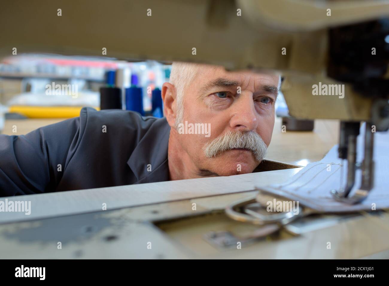 workman sewing leather boots on stitch lathe Stock Photo Alamy