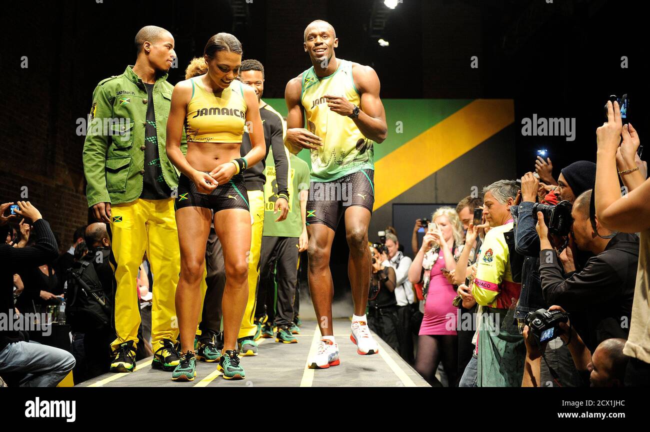 Jamaican sprinter Usain Bolt (R) models the Jamaican team's kit for the  London 2012 Olympic Games, designed by Cedella Marley, at a fashion show in  London June 1, 2012. REUTERS/Paul Hackett (BRITAIN -