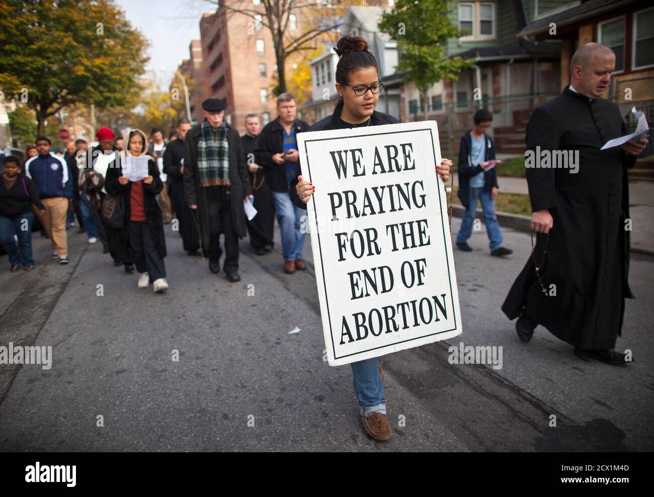 A woman holds a sign during an anti-abortion protest march to the Choices Women's Medical Center in Queens, New York October 20, 2012. The protest was organized by local church, Presentation of the Blessed Virgin Mary and targeted the center which offers abortion procedures. REUTERS/Andrew Kelly (UNITED STATES - Tags: CIVIL UNREST POLITICS) Stock Photo