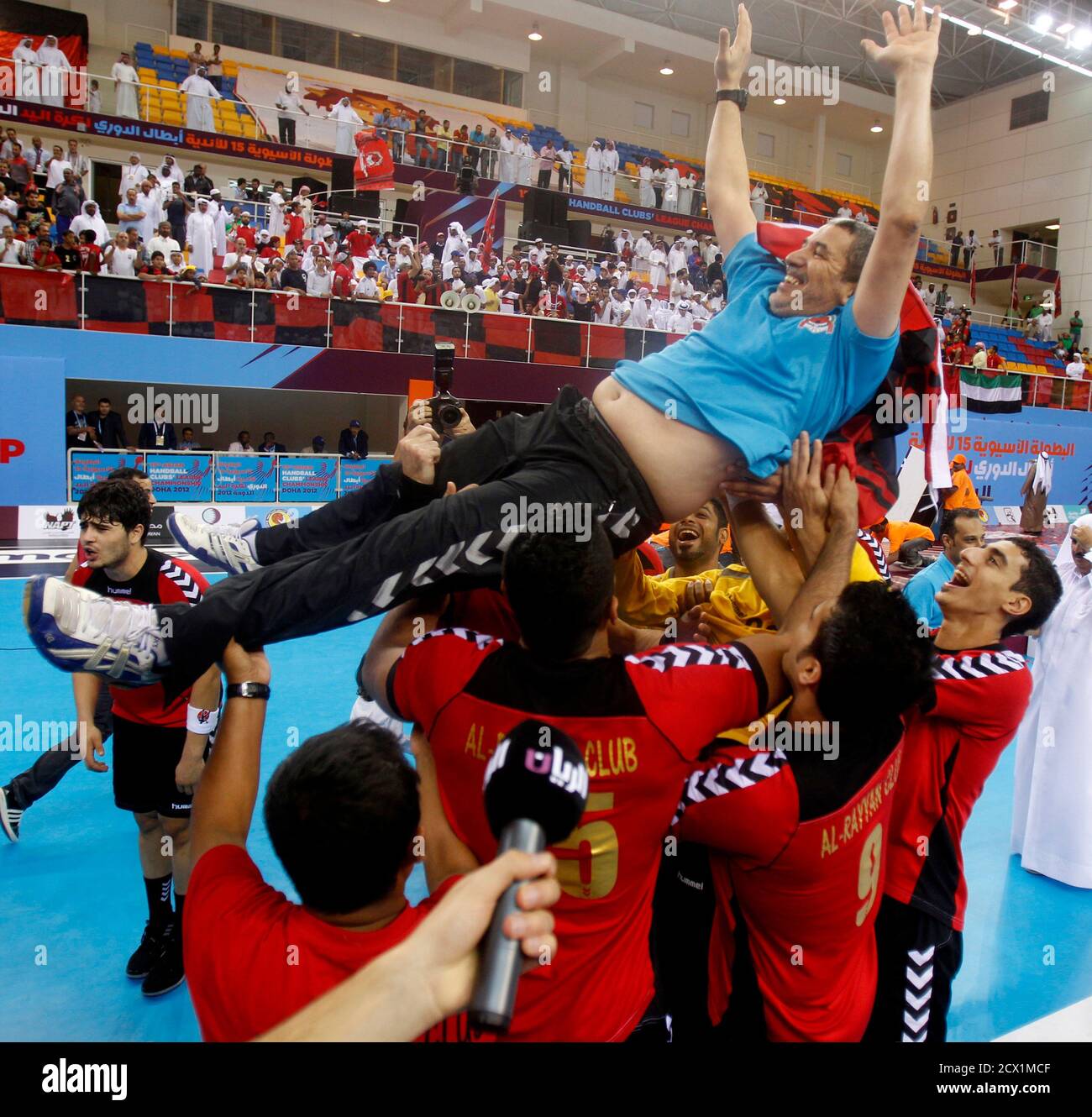 Qatar S Al Rayyan Head Coach Kamal Akab Top Celebrates With His Players After Winning The Gold Medal Match At The Asian Handball Club Championship Against Uae S Al Ahly In Doha November 15 2012