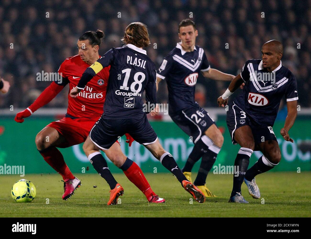 Paris Saint-Germain's Zlatan Ibrahimovic (L) challenges Bordeaux's Jaroslav  Plasil (C) as Henrique Dit (R) and Gregory Sertic (2ndR) look on during  their French Ligue 1 soccer match at the Chaban Delmas Stadium