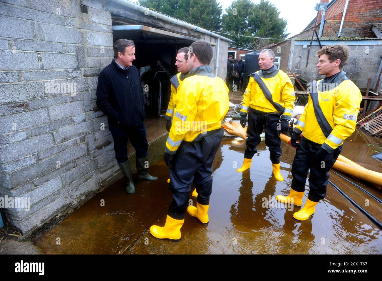 Britain's Prime Minister David Cameron talks with emergency service workers during a visit to a flood affected area at Goodings Farm in Fordgate, Somerset February 7, 2014.    REUTERS/Tim Ireland/Pool (BRITAIN - Tags: DISASTER POLITICS ENVIRONMENT) Stock Photo