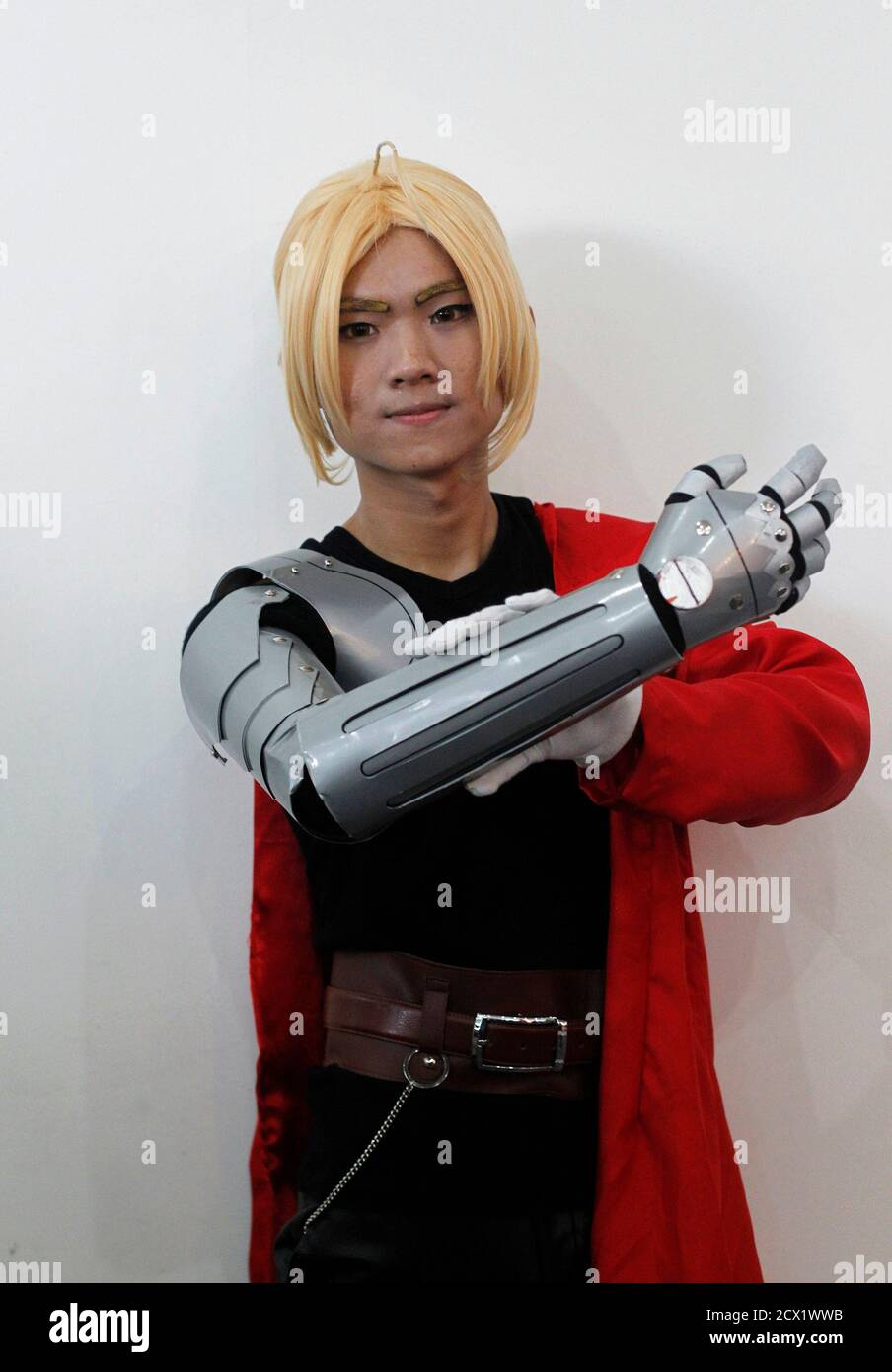 A youth, dressed as the character Edward Elric from "Fullmetal Alchemist",  poses for a picture during a cosplay competition at Saya San Plaza in  Yangon August 3, 2014. Shut off from the