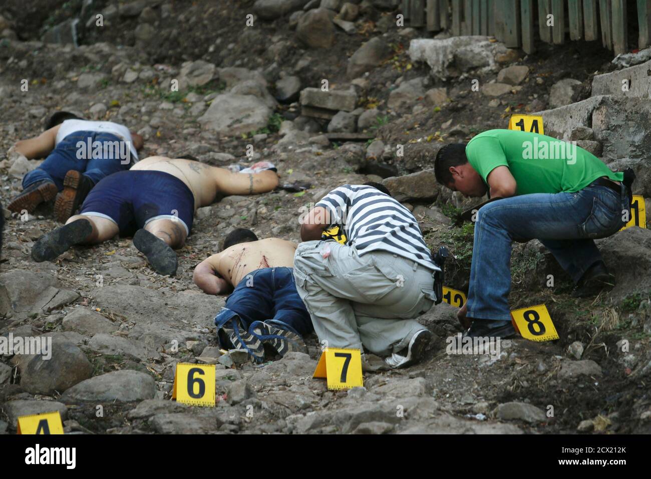 ATTENTION EDITORS - VISUAL COVERAGE OF SCENES OF INJURY OR DEATH  Three unidentified slain men lay dead at Nueva Danli neighborhood in Tegucigalpa, November 28, 2010. According to Ramon Custodio, National Commissioner of Human Rights, the rate of homicides in 2010 in Honduras was of 72.8 homicides per 100,000 inhabitants, the highest in the world. REUTERS/Edgard Garrido (HONDURAS - Tags: OBITUARY CIVIL UNREST) Stock Photo