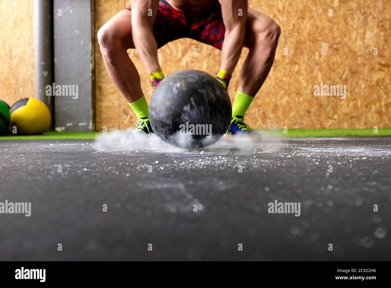 Powerful shirtless male throwing heavy ball against ground during fitness workout in gym Stock Photo Alamy