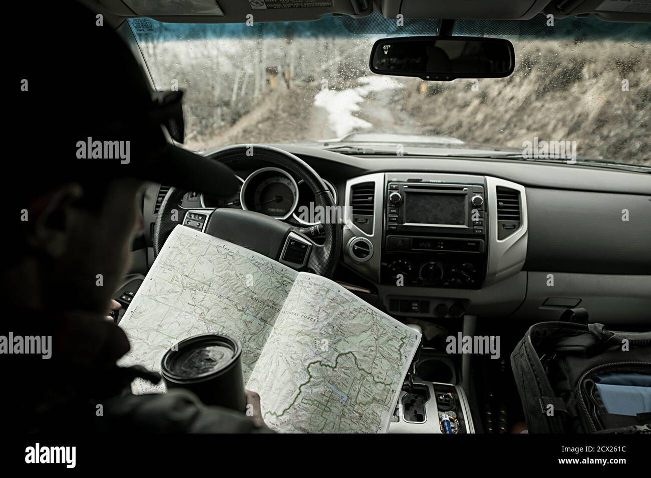 Man reading map while traveling in car Stock Photo