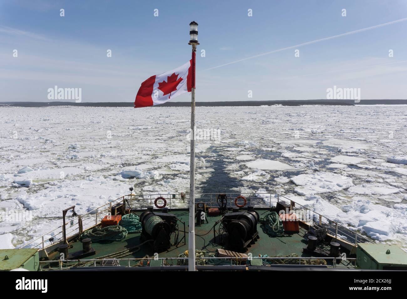 Canadian Flag waving on ship in frozen sea against sky Stock Photo Alamy