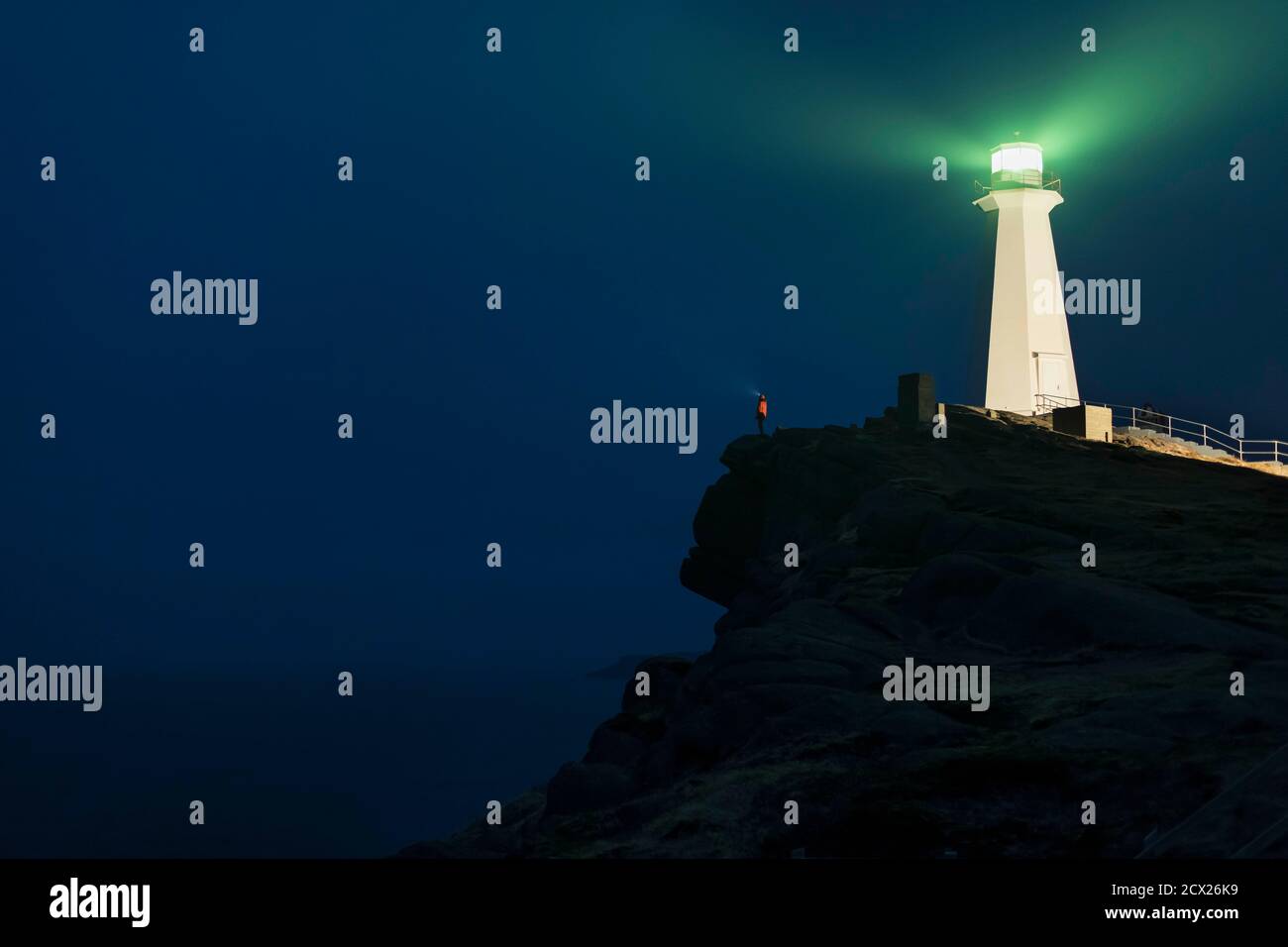 Low angle view of Illuminated lighthouse on mountain against sky at ...