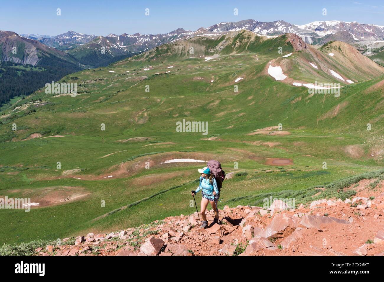 Rear view of woman hiking on mountain during summer vacation Stock ...