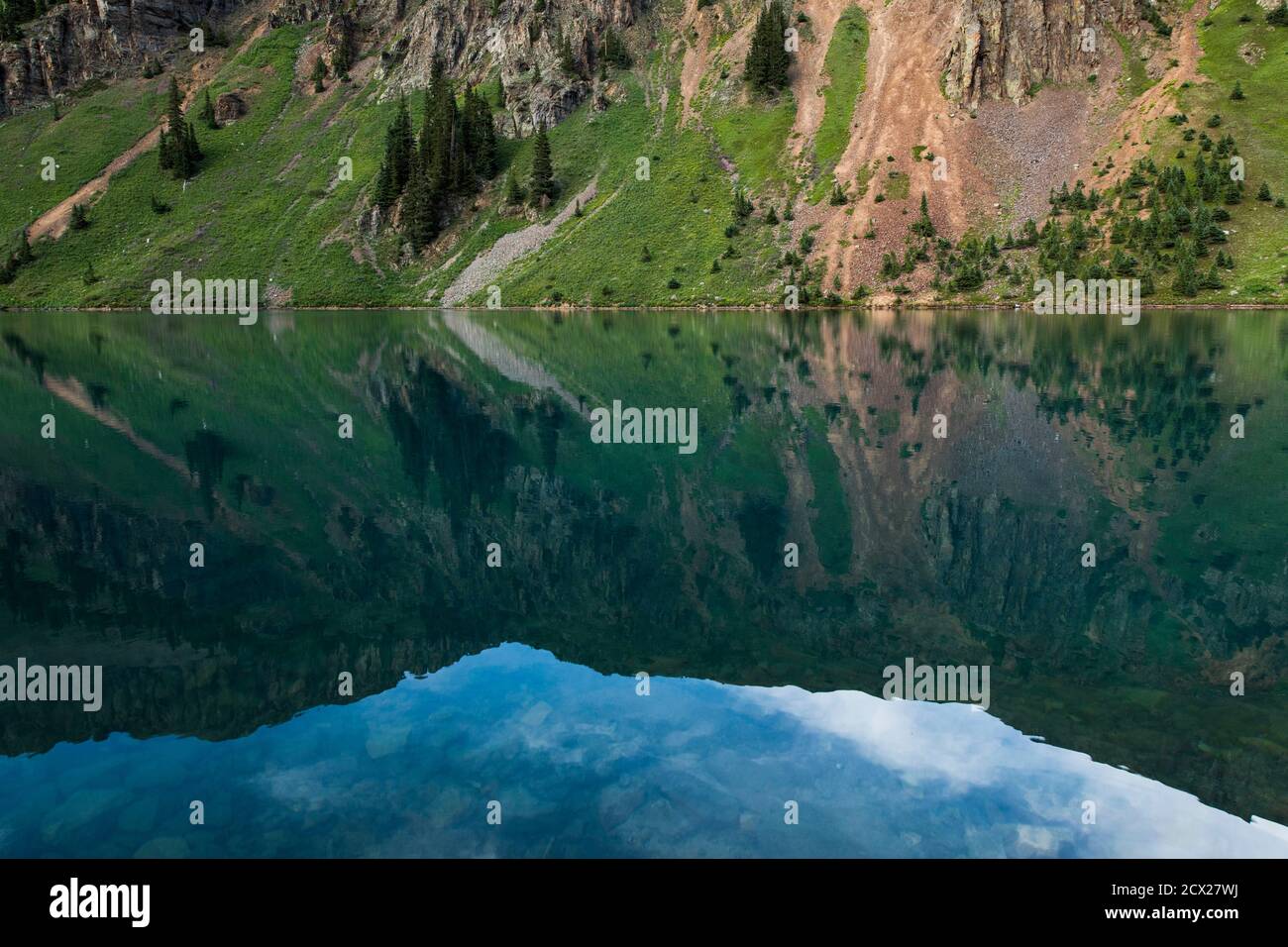 Reflection of mountain on calm lake Stock Photo - Alamy