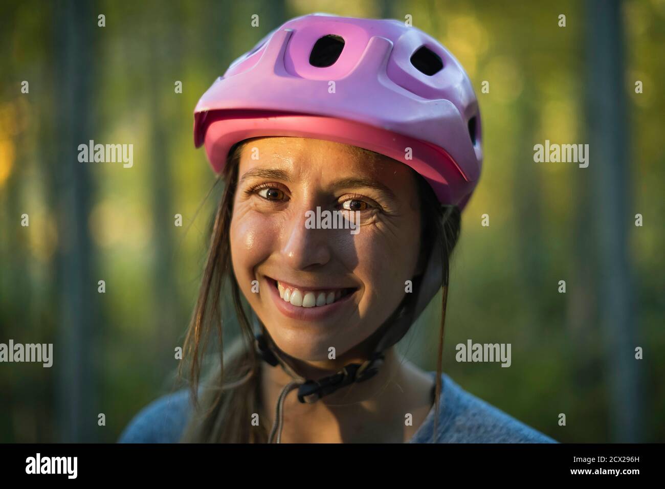 Smiling young woman wearing helmet hi-res stock photography and images ...